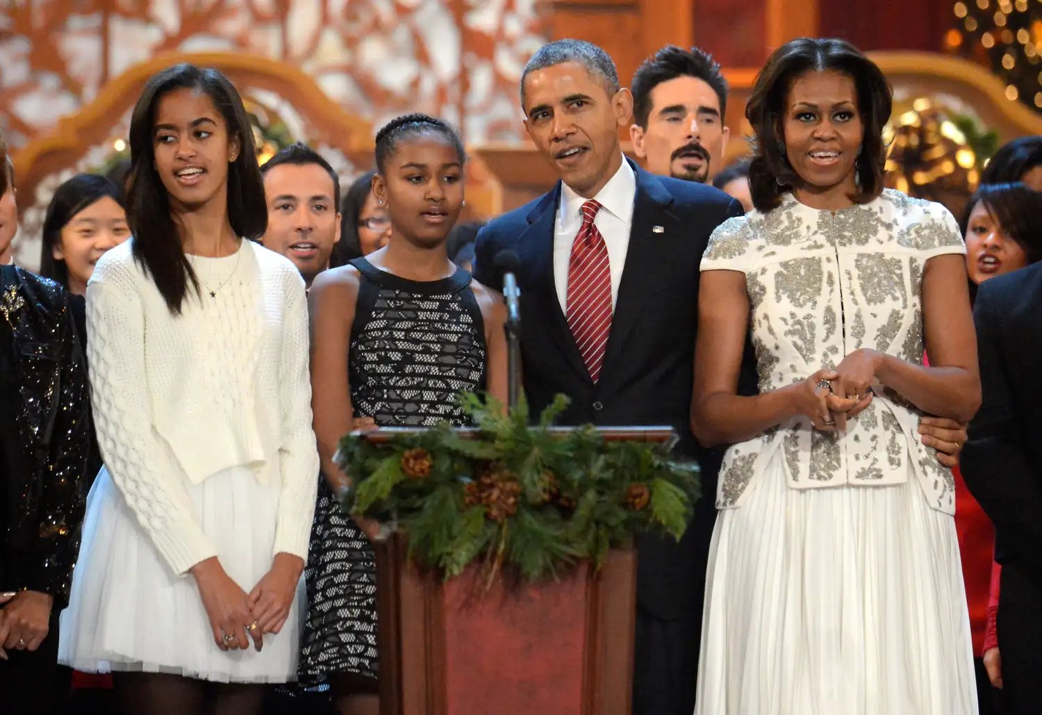 Malia Obama, Sasha Obama, Barack Obama, and Michelle Obama on stage at Christmas