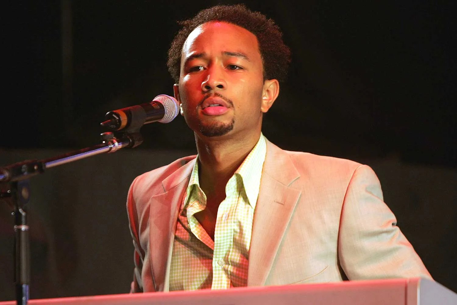 John Legend performs onstage during Kanye West's performance at "The Truth Tour 2004" at the Wachovia Center August 19, 2004 in Philadelphia, Pennsylvania.