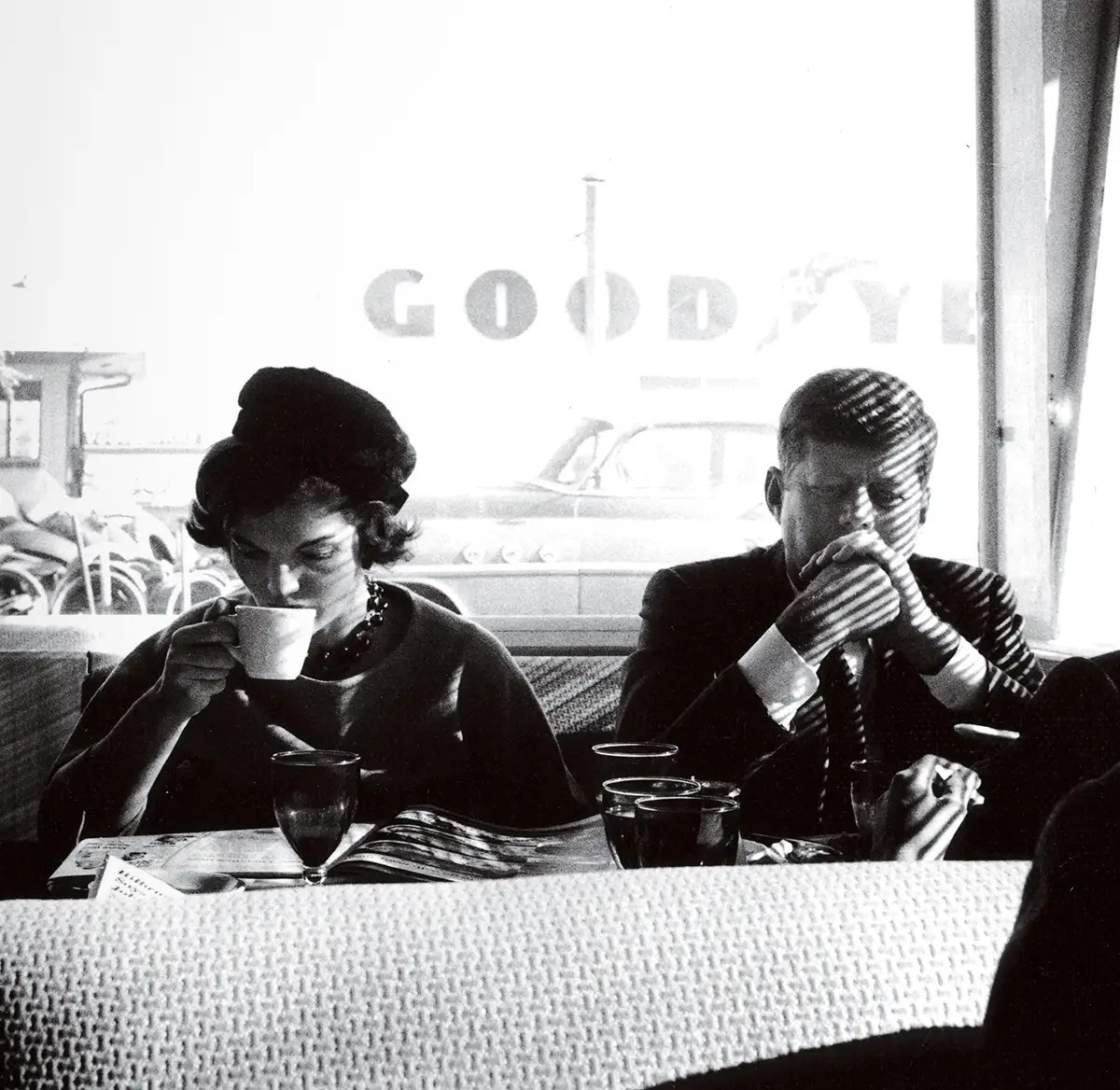 Jacqueline Kennedy (née Bouvier, 1929 - 1994) and Senator (and future US President) John F. Kennedy (1917 - 1963) (center), along with the latter's brother-in-law and campaign strategist Stephen Edward Smith (1927 - 1990), as they eat together in a diner, Pendleton, Oregon, late Fall 1959.