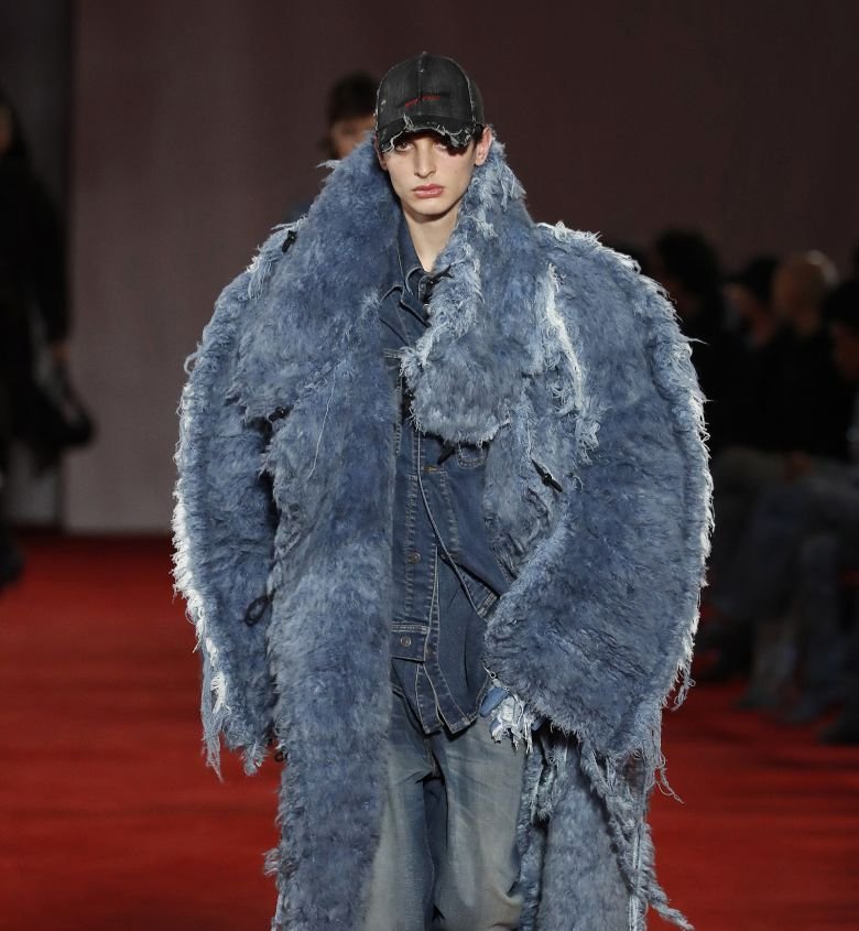 A runway look from Diesel's fall-winter 2022 collection exhibited alongside the Lotto painting at the Cleveland Museum of Art.