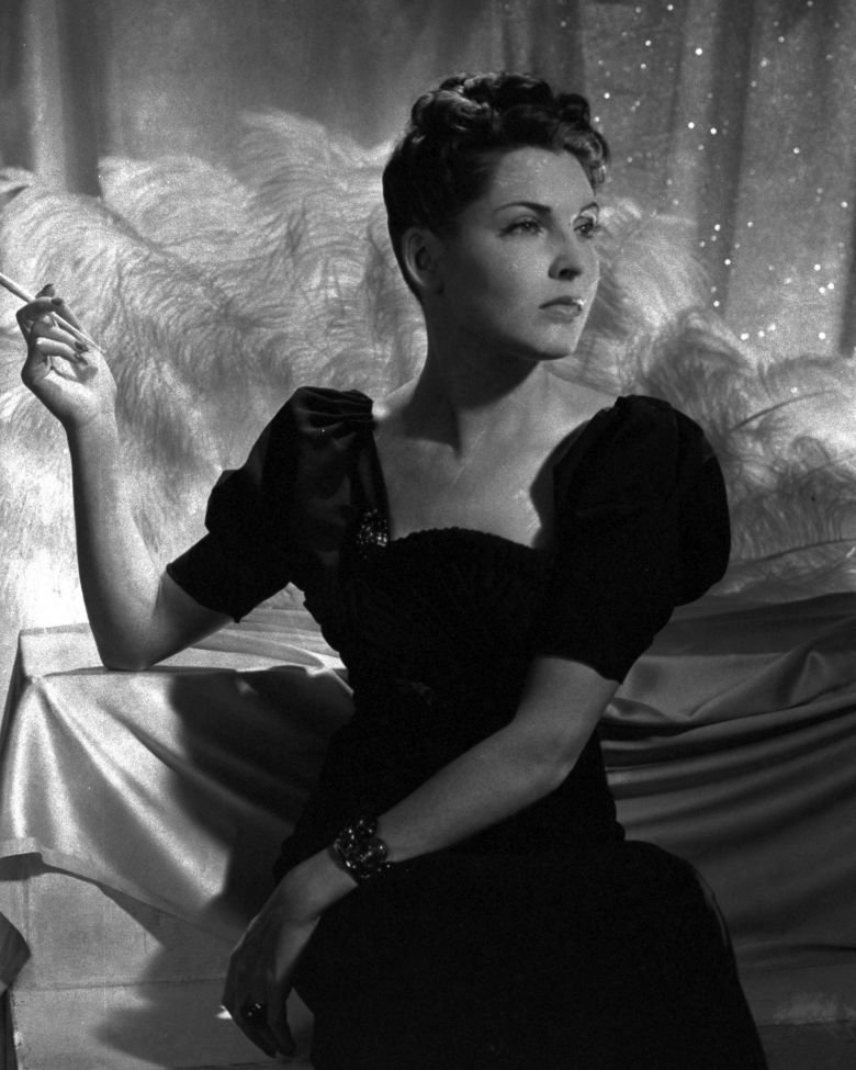 Socialite Dorothy Hart Hearst in a 1938 issue of Vogue, wearing a puff-sleeve crepe dress by Elsa Schiaparelli.