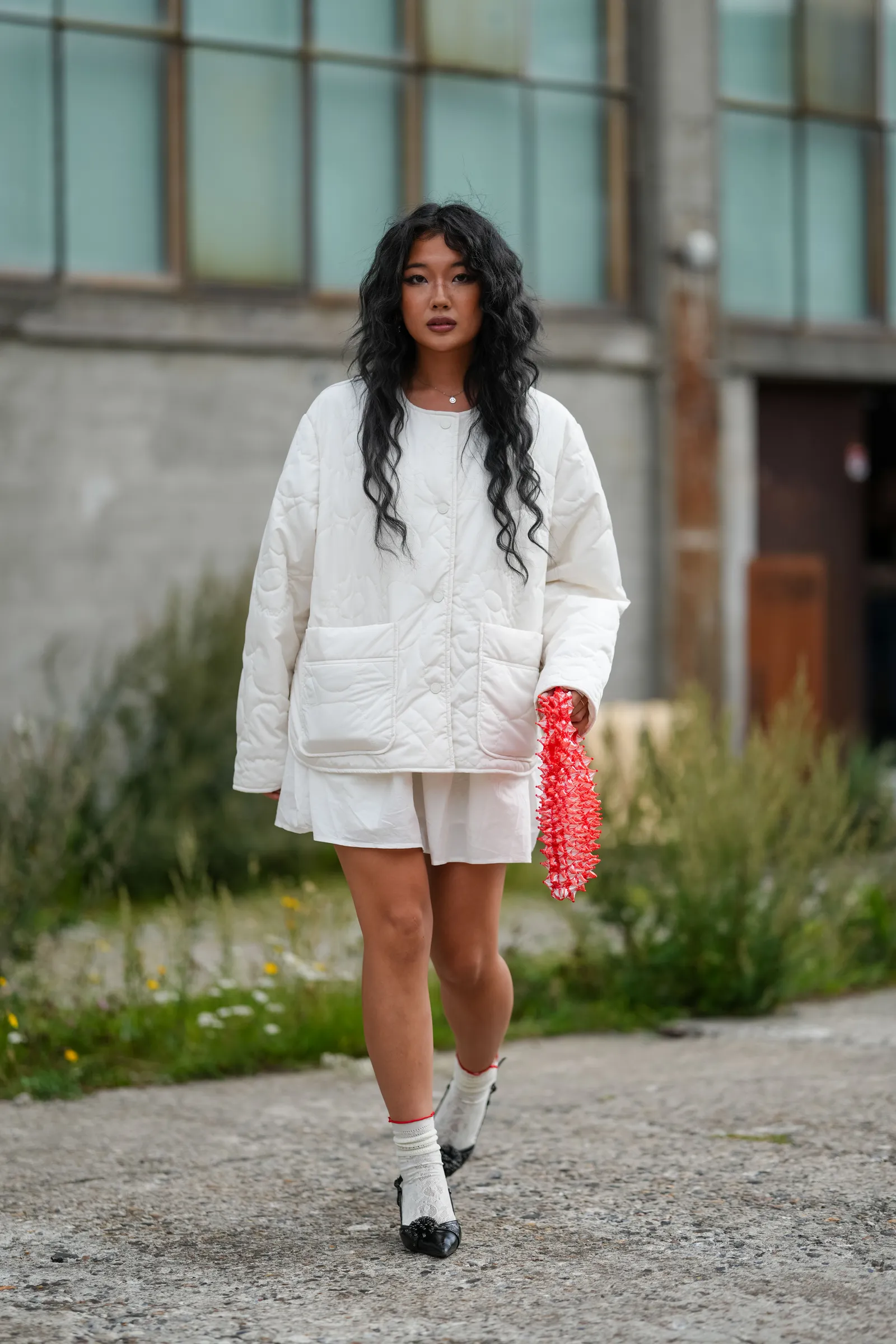 COPENHAGEN DENMARK  AUGUST 07 A guest wears long wavy dark hair in a center part soft neutral makeup with defined brows...