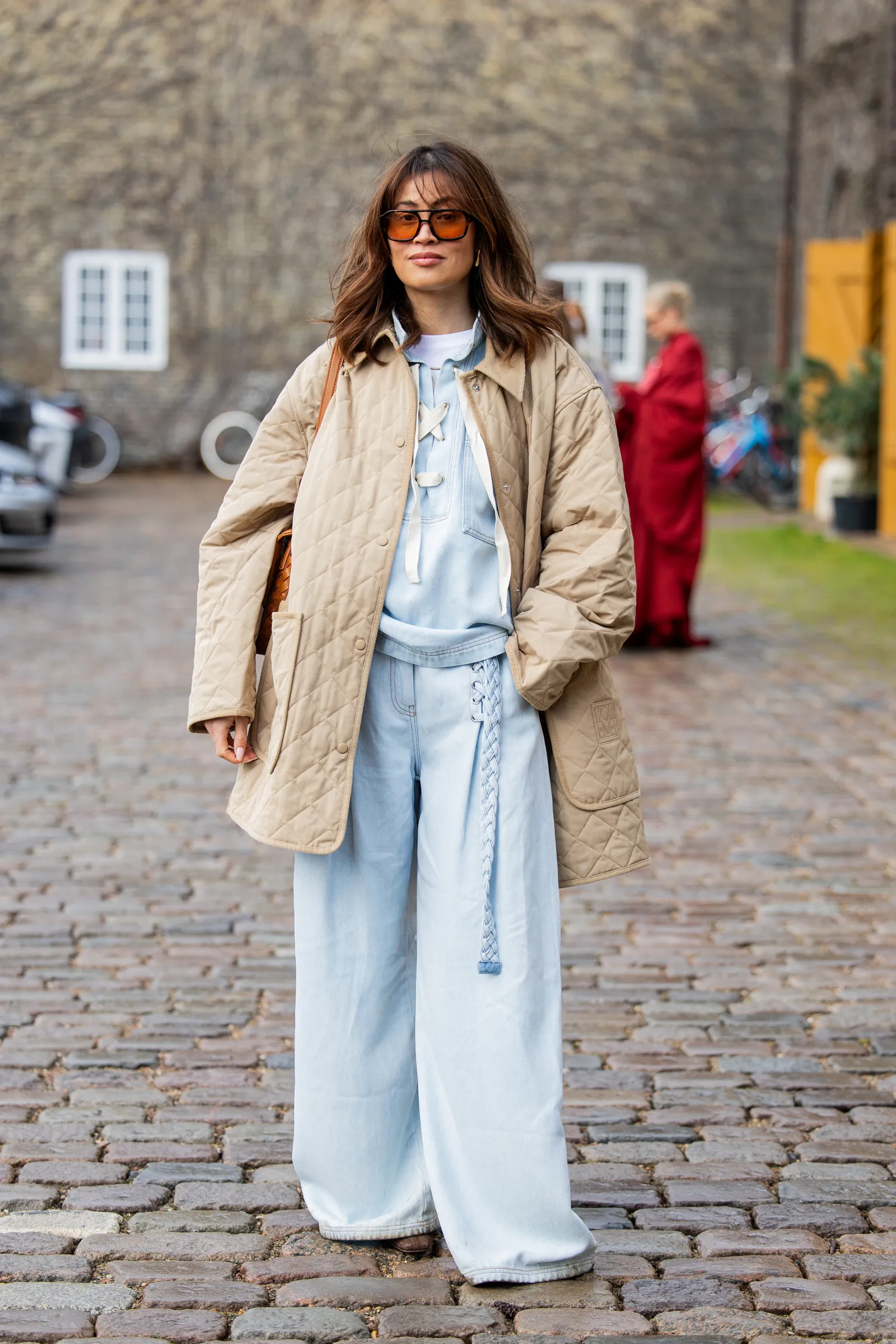COPENHAGEN DENMARK  JANUARY 30 Michelle Elie wears wide leg blue pants beige jacket top outside Munthe during the...