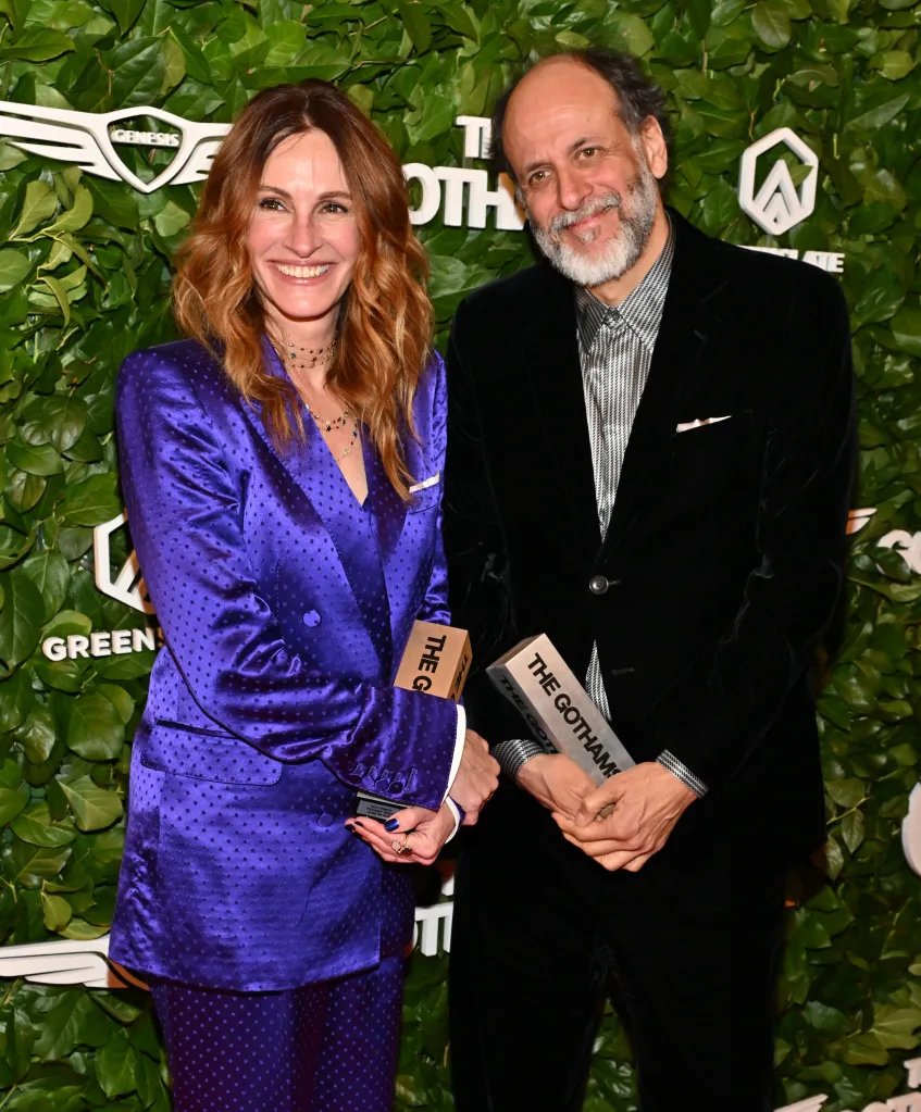 Julia Roberts and Luca Guadagnino smiling while holding their awards at the 35th Edition of The Gotham Film Awards.