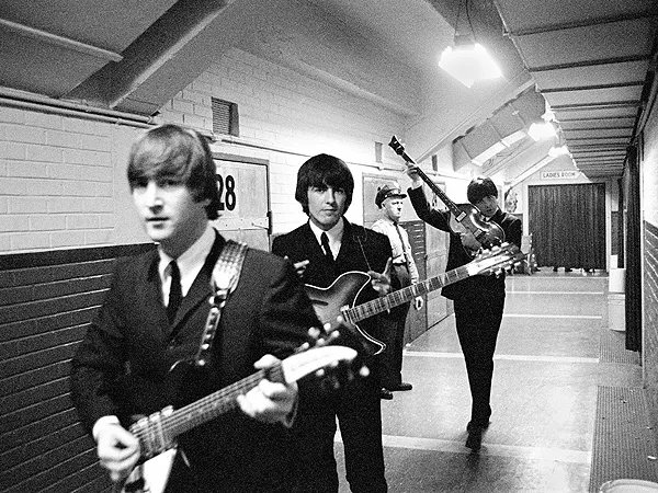 John Lennon, George Harrison and Paul McCartney pictured backstage in 1964