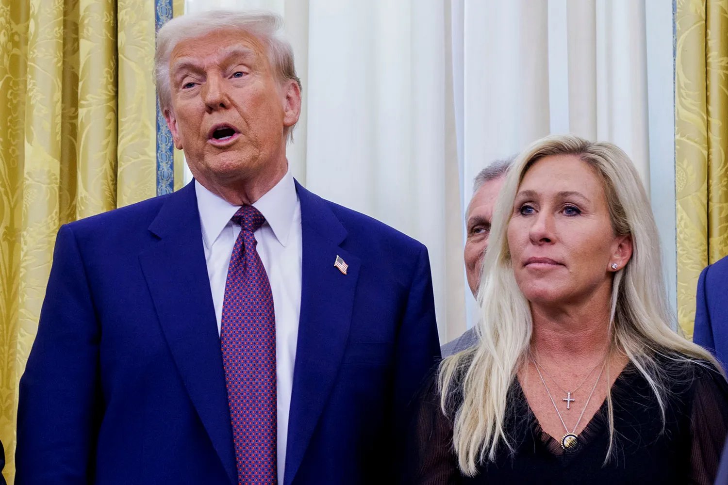 US President Donald Trump, Georgia Republican Representative Marjorie Taylor Greene, during a ceremony in the Oval Office of the White House in Washington, DC, US, on Thursday, Feb. 13, 2025.