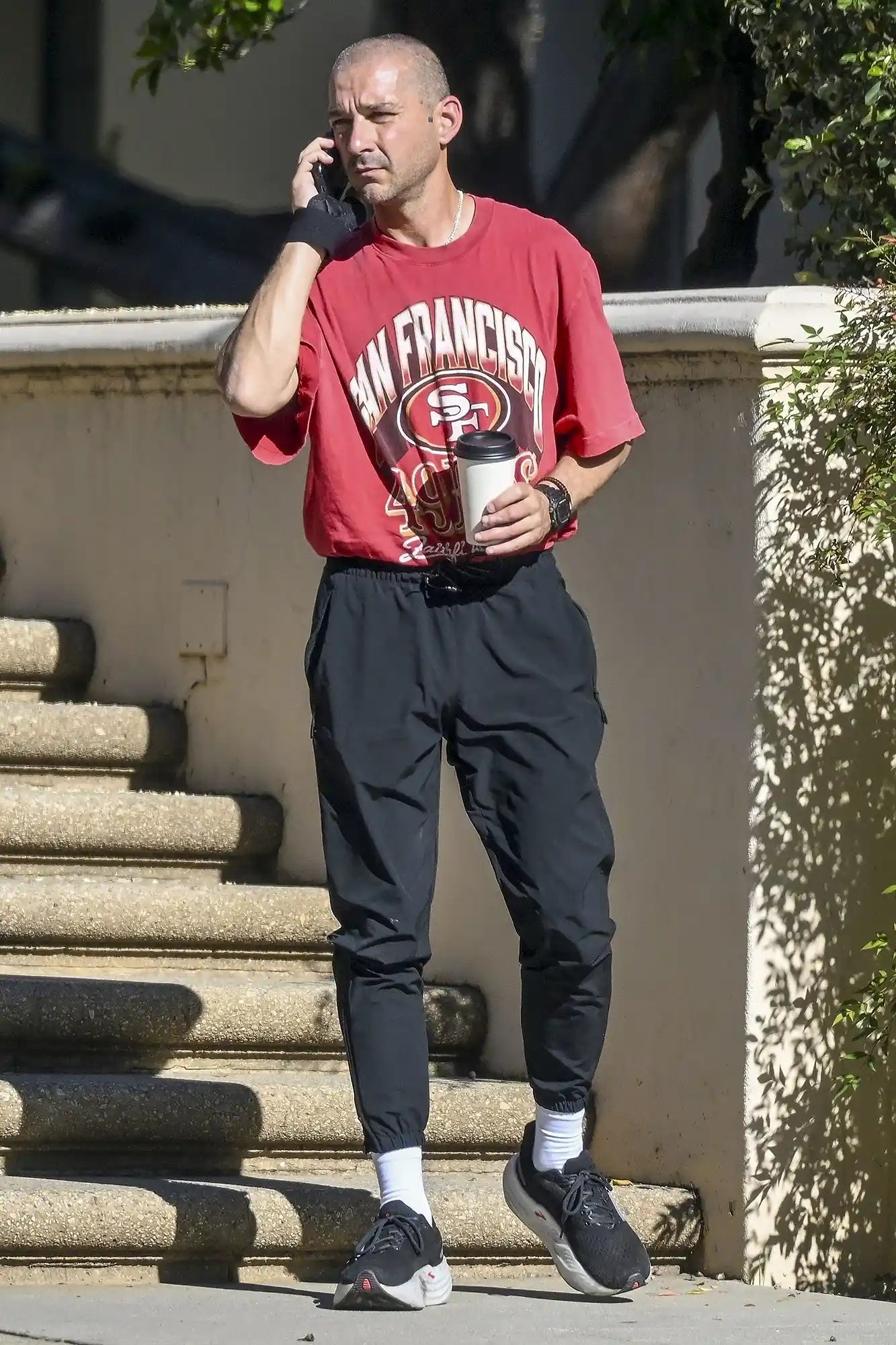 *EXCLUSIVE* Los Angeles, CA Shia LaBeouf makes a dramatic return after months away, showcasing a completely unrecognizable look with a freshly shaved head. The actor was spotted talking on his phone and drinking coffee.