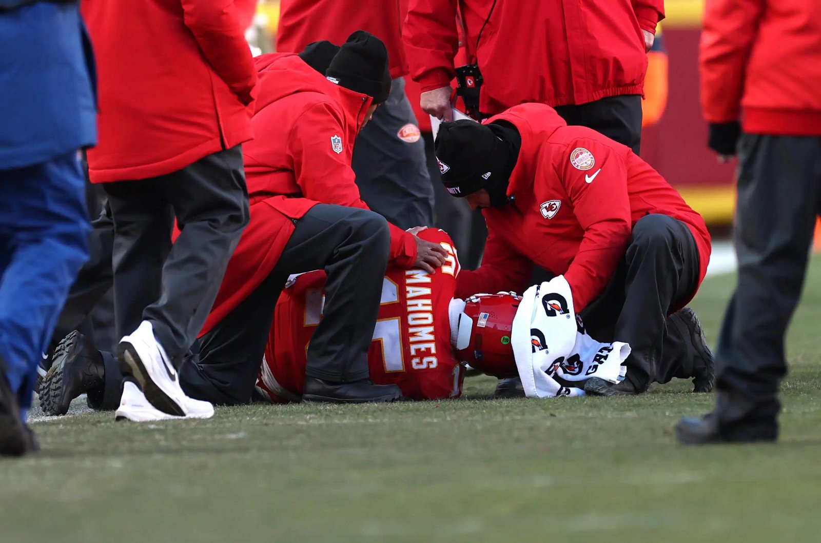 Patrick Mahomes #15 of the Kansas City Chiefs lays on the ground after sustaining an injury during the fourth quarter against the Los Angeles Chargers at Arrowhead Stadium on December 14, 2025 in Kansas City, Missouri.