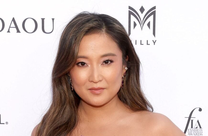 Ashley Park Embraces the Cherry Cola Hair Trend in a Stunning Lingerie-Inspired Corset Gown