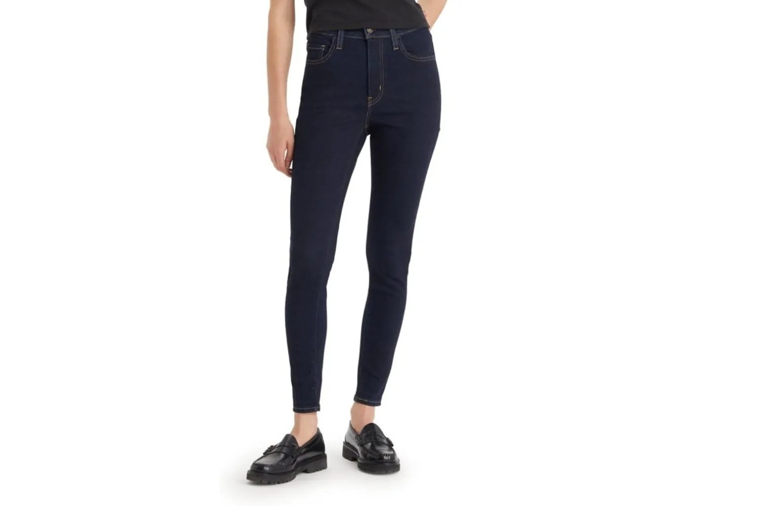 Person wearing Levi's women's 720 high-rise super skinny jeans and loafers