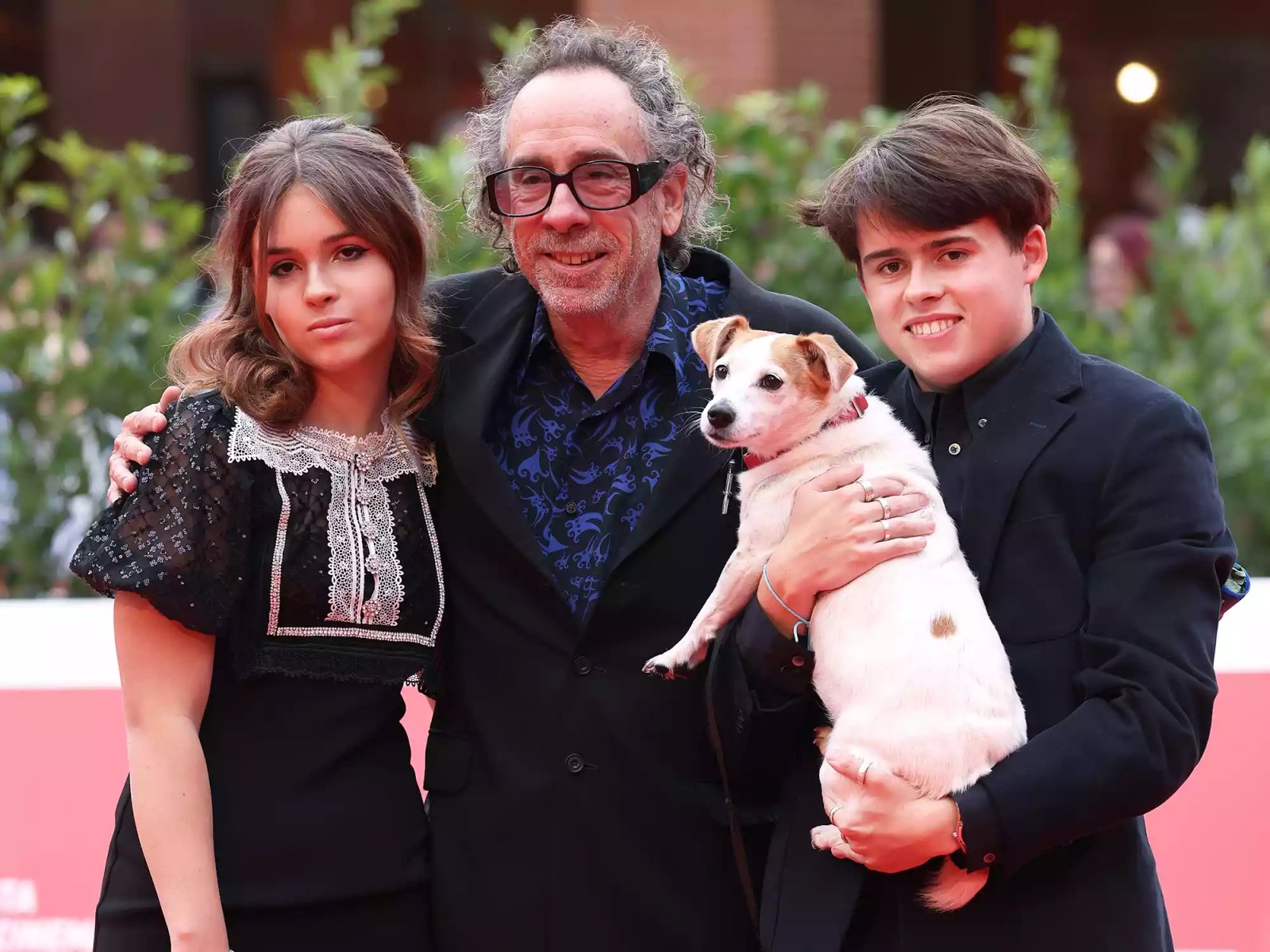 Nell Burton, Tim Burton, Billy-Ray Burton, and Levi the dog attend the Tim Burton Close Encounter red carpet during the 16th Rome Film Fest on October 23, 2021.