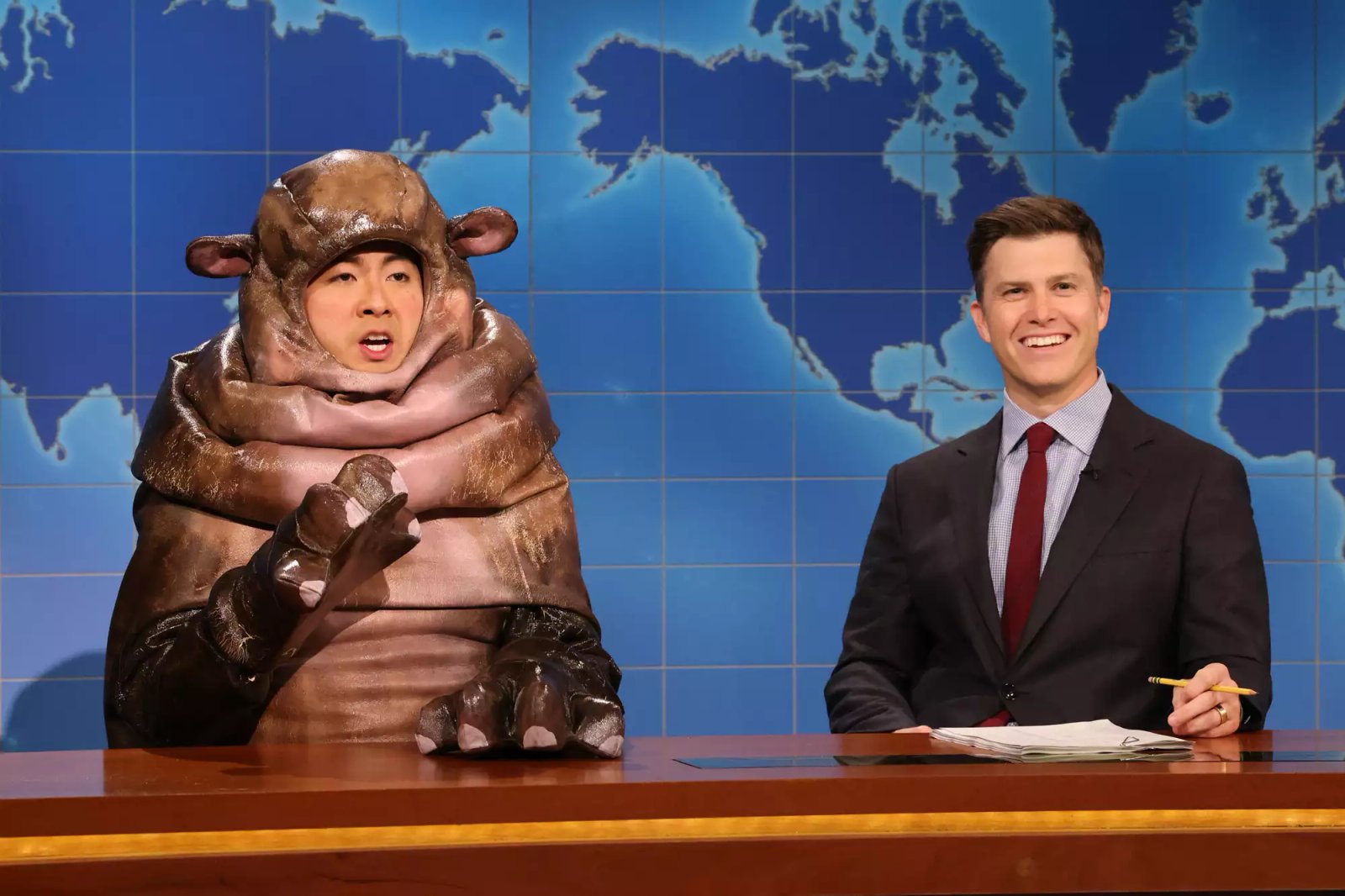 Bowen Yang as Moo Dang the hippo and Colin Jost during Weekend Update on Saturday Night Live.