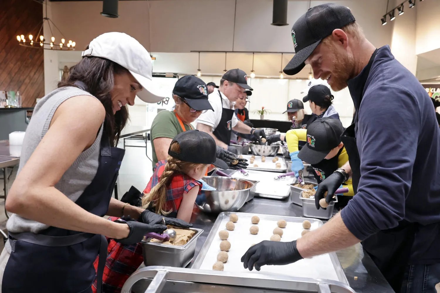 Prince Harry and Meghan, Duke and Duchess of Sussex, alongside the Archewell team, prepare meals for community members experiencing food insecurity.