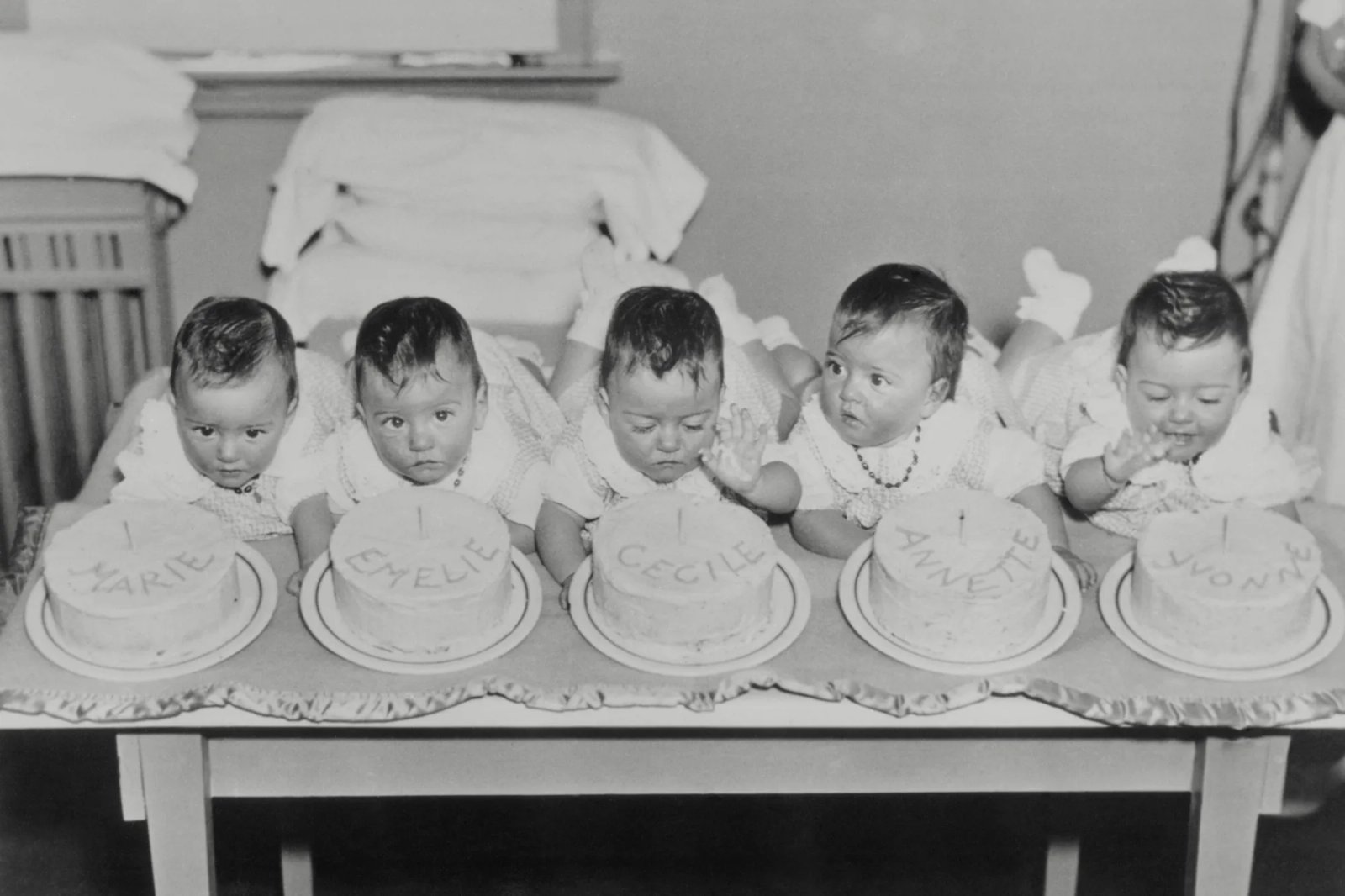The Dionne quintuplets--Marie, Emelie, Cecile, Annette and Yvonne celebrate their first birthday in style in Callander, Ontario, on May 28, 1935.