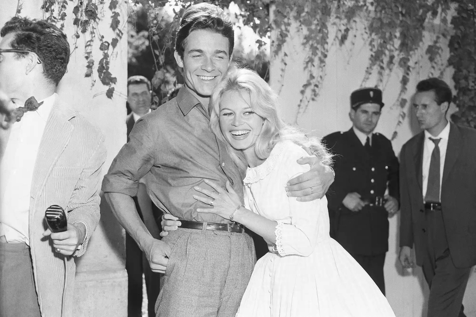 (Original Caption) 2/18/1959-Louveciennes, France: Actress Brigitte Bardot, 23, gets a hug from her new husband, actor Jacques Charrier, also 23, following their wedding here, June 18th.