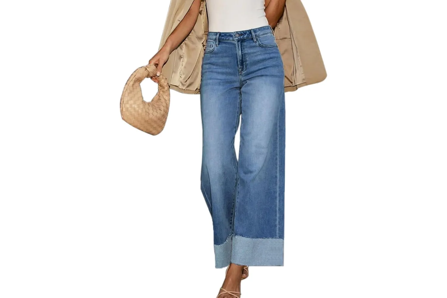 Person wearing wideleg jeans with a beige jacket over their shoulders