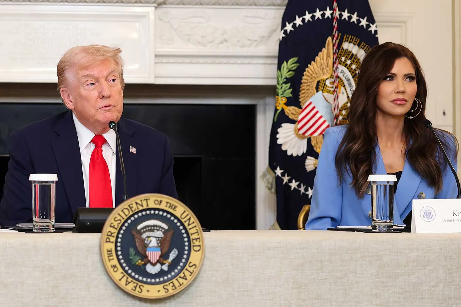 President Donald Trump and Kristi Noem during a roundtable discussion in the State Dining Room of the White House on October 08, 2025 in Washington, DC.