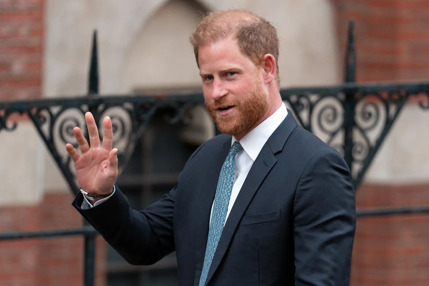 Prince Harry, Duke of Sussex waves as he leaves the High Court