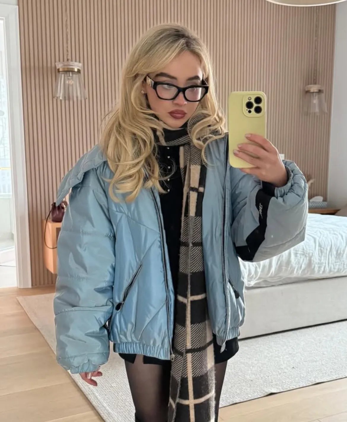 Sabrina Carpenter showing off a chic blue puffer coat