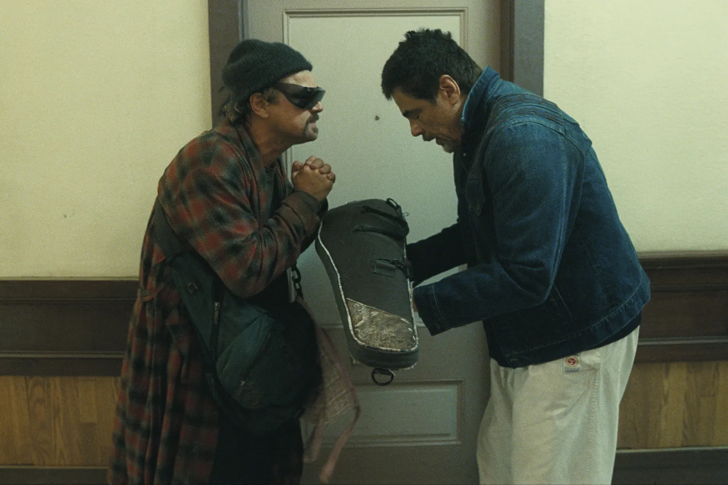Leonardo DiCaprio as Bob Ferguson and Benicio Del Toro as Sensei St. Carlos in One Battle After Another.