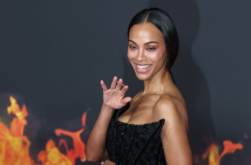 Zoe Saldaña Looks Radiant in a Sheer Brown Lace Halterneck Gown in Year-End Video