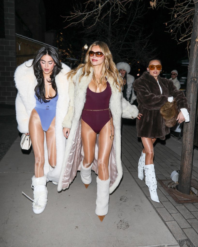 Brooks Nader and her sisters Mary Holland, Grace Ann, and Sarah Jane, wearing fur coats over swimsuits with winter boots.