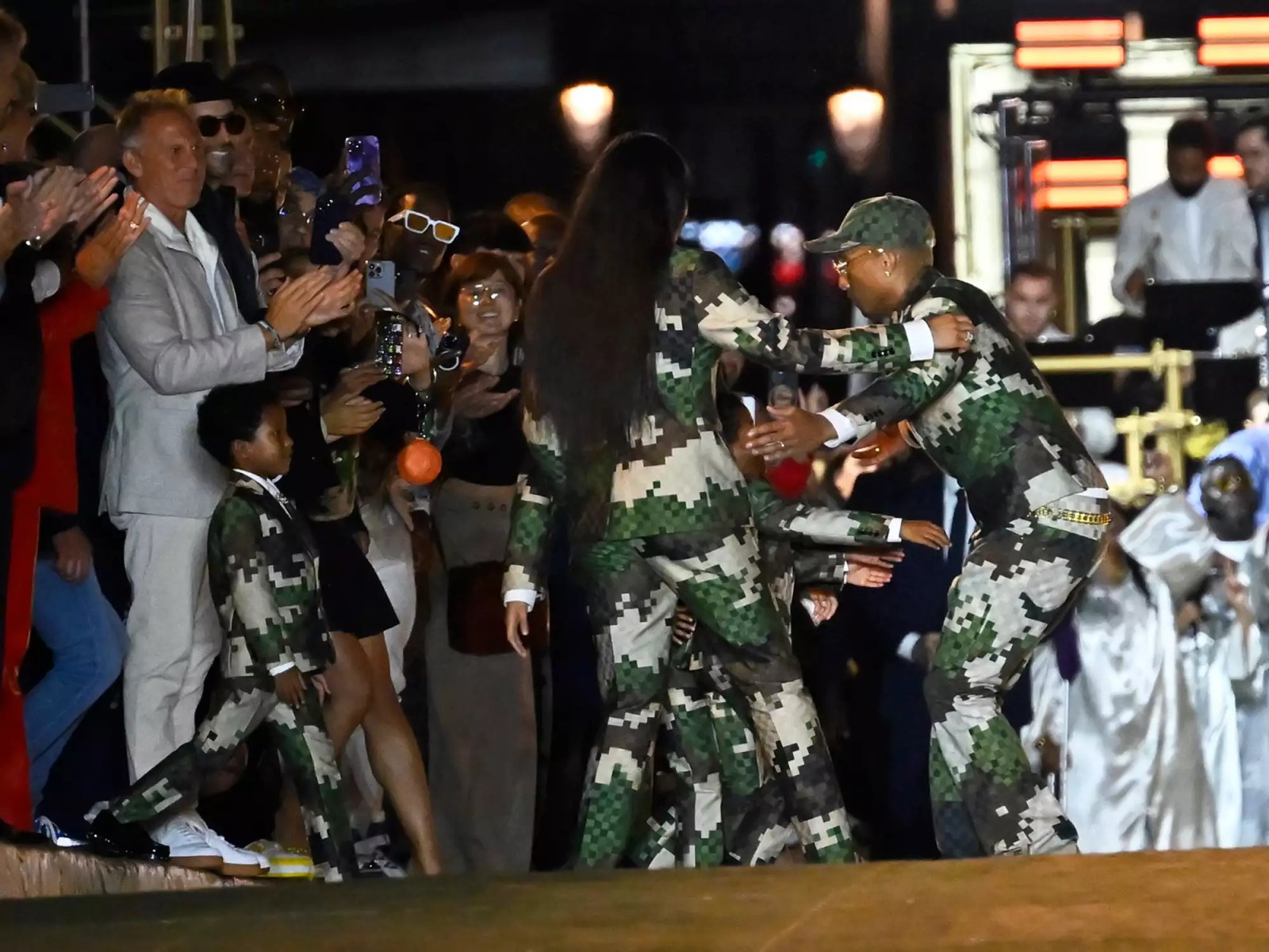 Pharrell Williams embraces his family, wife Helen Lasichanh and children, after the Louis Vuitton Menswear Spring/Summer 2024
