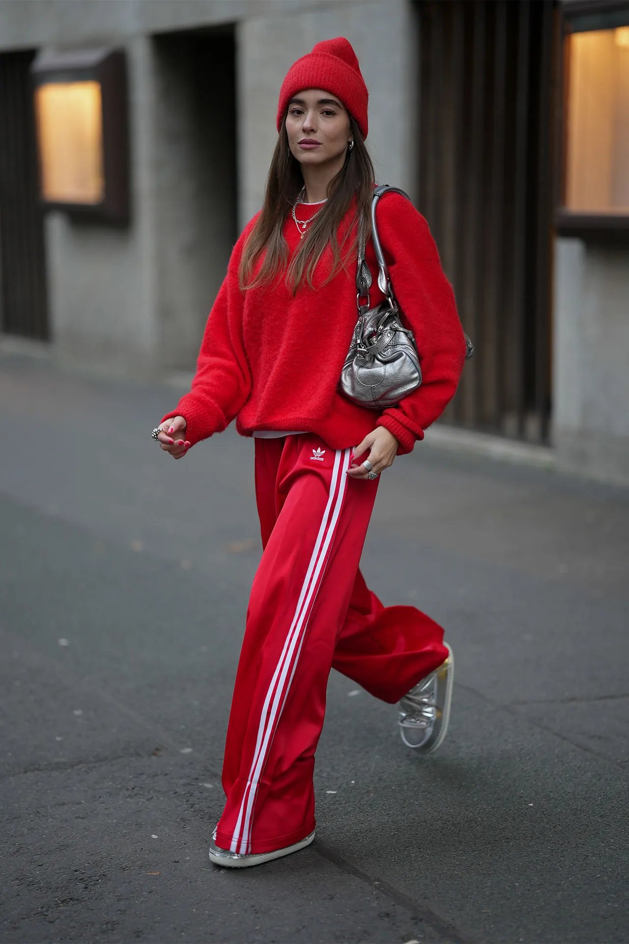 Image may contain Person Walking Adult Pedestrian Clothing Pants Cap Hat and Coat