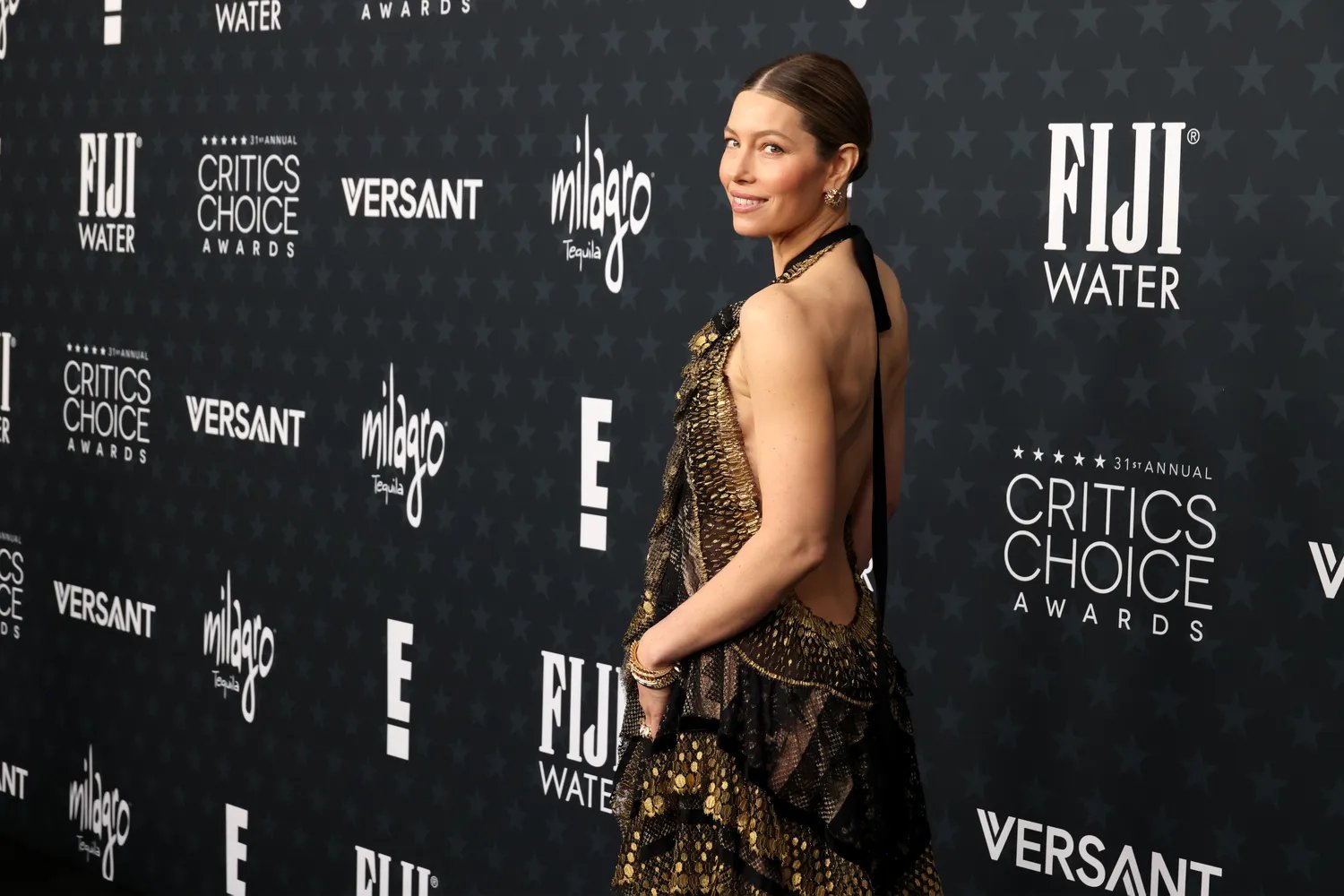 Jessica Biel in a gold sequined gown with a slick bun at the Critics Choice Awards