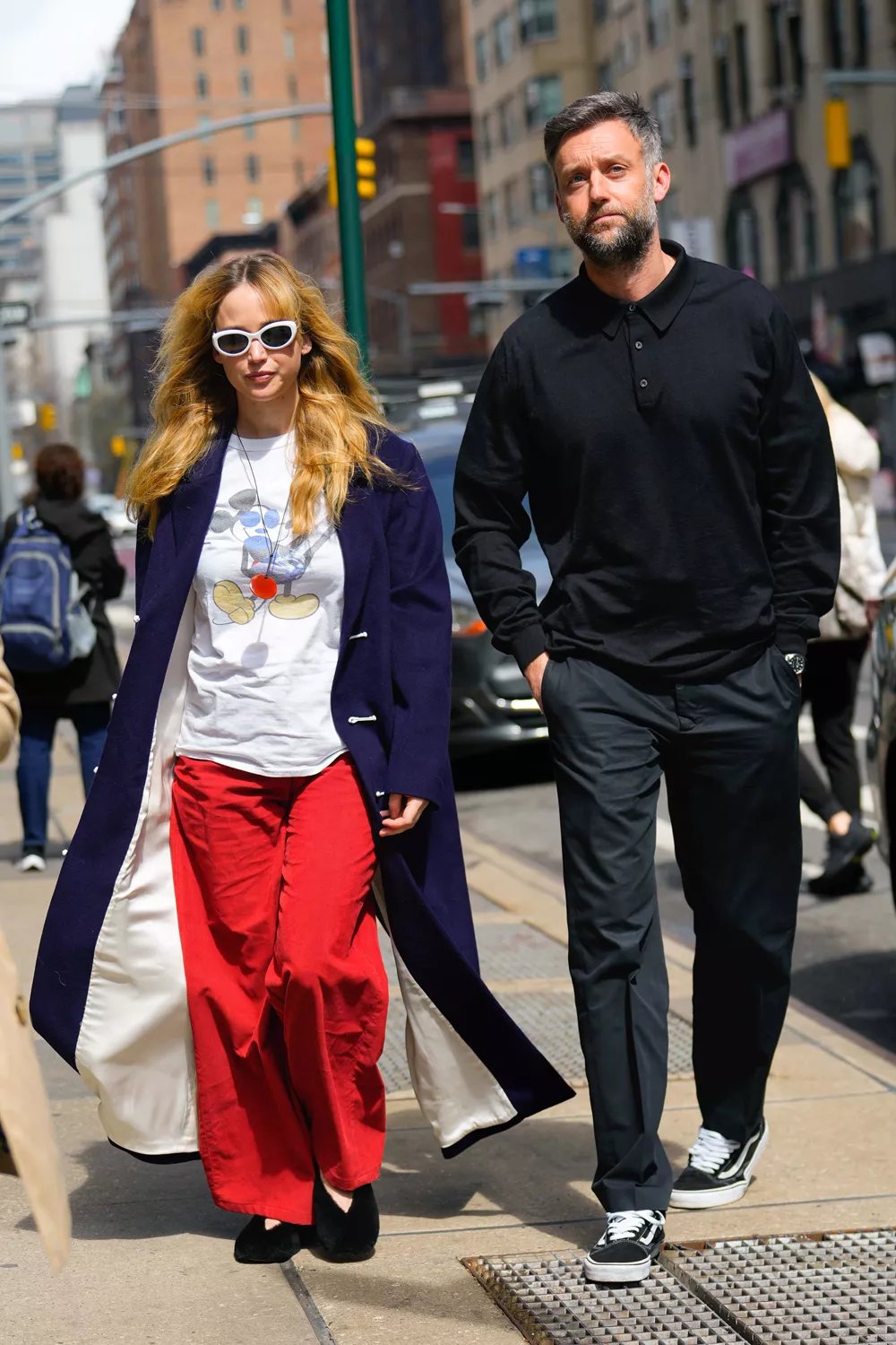 Jennifer Lawrence and Cooke Maroney step out together in New York City, with Lawrence carrying a red handbag and dressed stylishly.