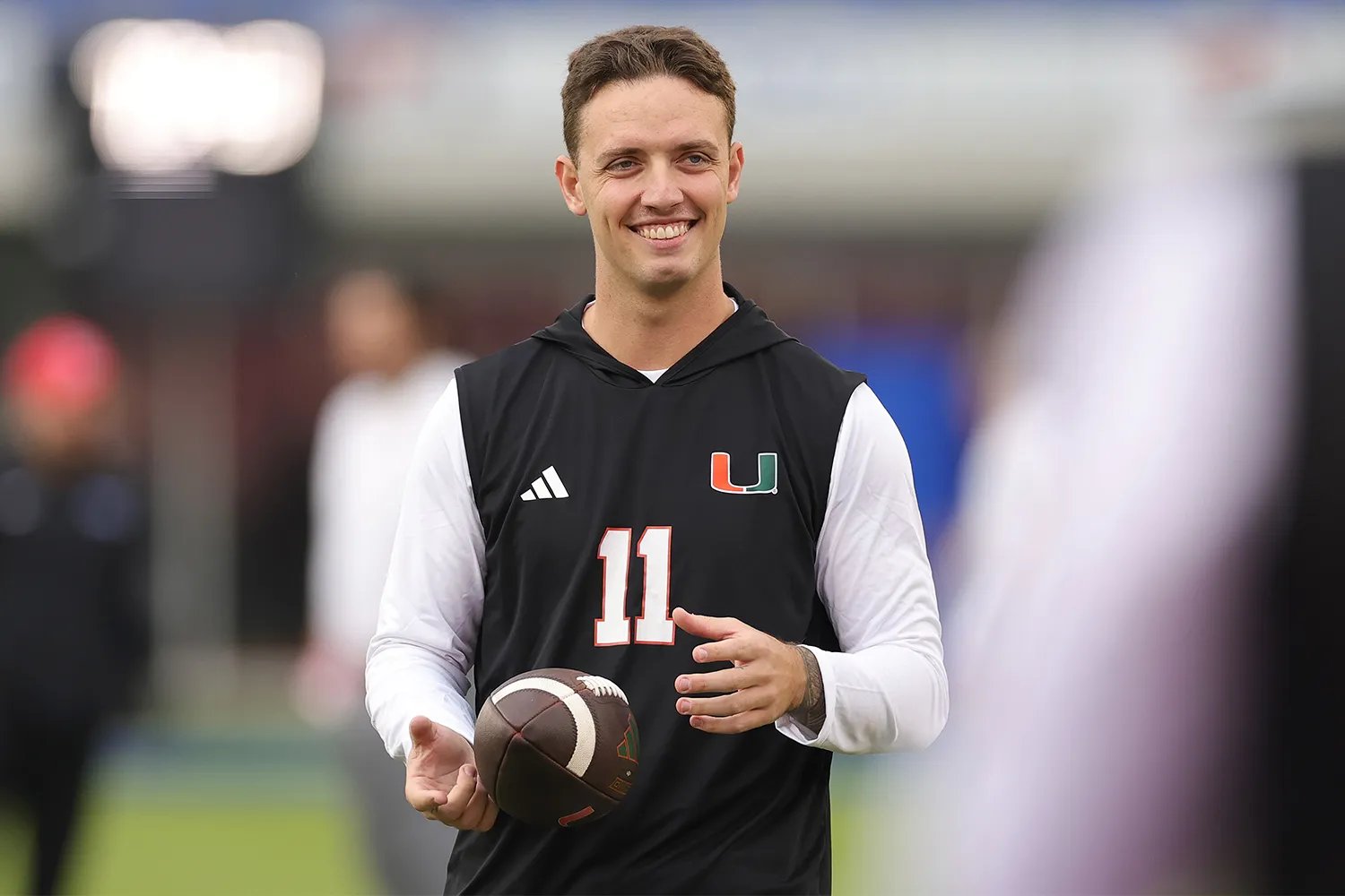 Carson Beck #11 of the Miami Hurricanes participates in warmups