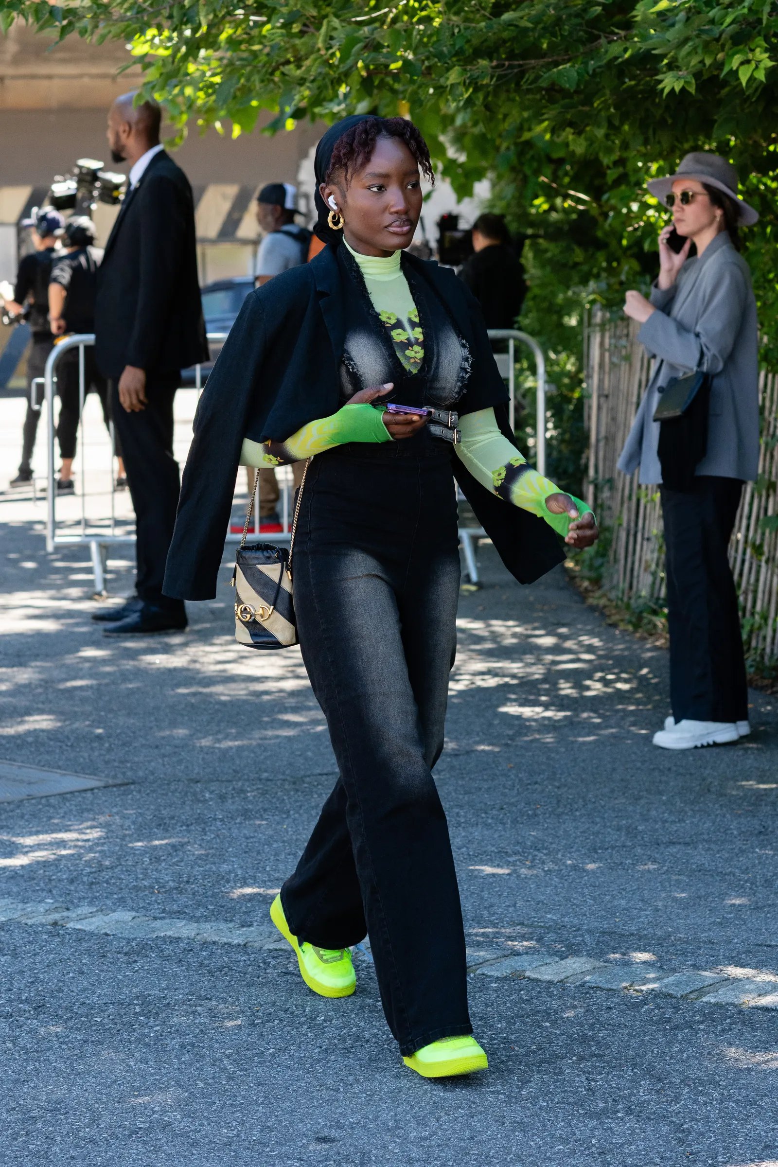 Image may contain Fatima Siad Person Walking Clothing Pants Footwear Shoe Accessories Bag Handbag Hat and Adult