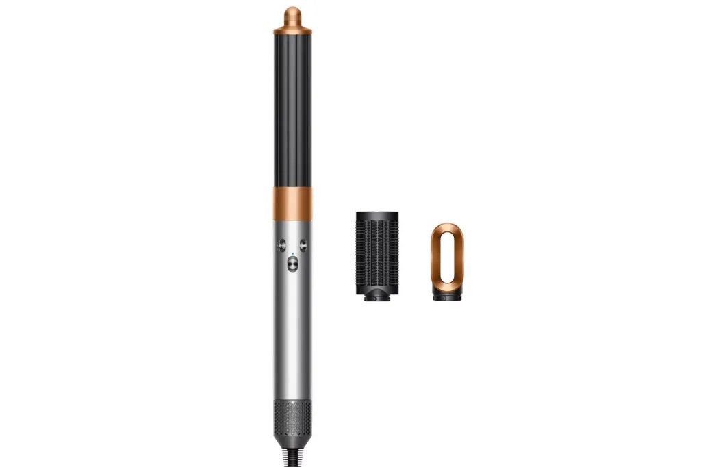 Dyson Airwrap styler in bronze and black, with a brush attachment and an oval-shaped attachment next to it.
