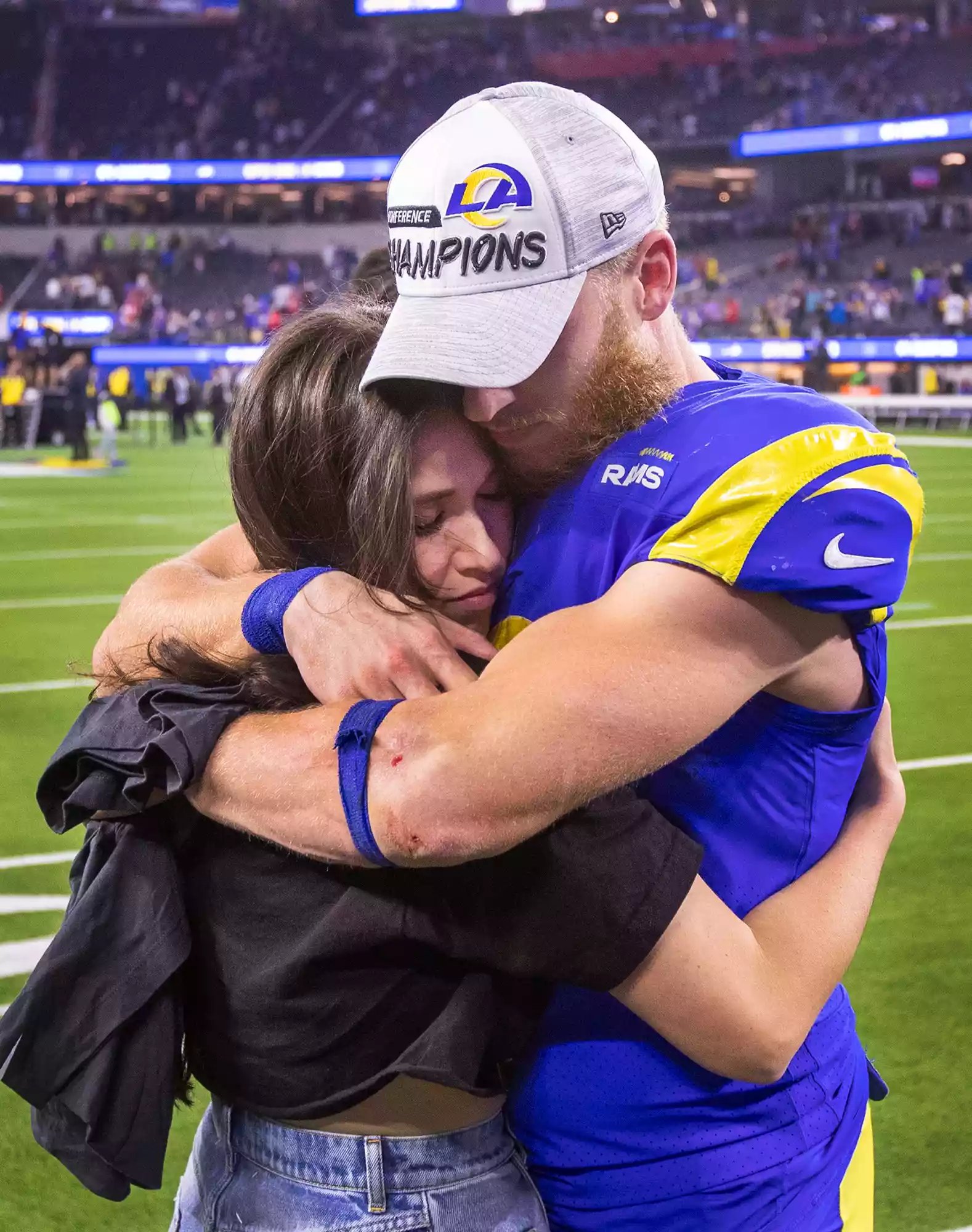 Cooper Kupp hugs his wife Anna as they celebrate a win at the NFC Championships at SoFi Stadium on Jan. 30, 2022, in Los Angeles