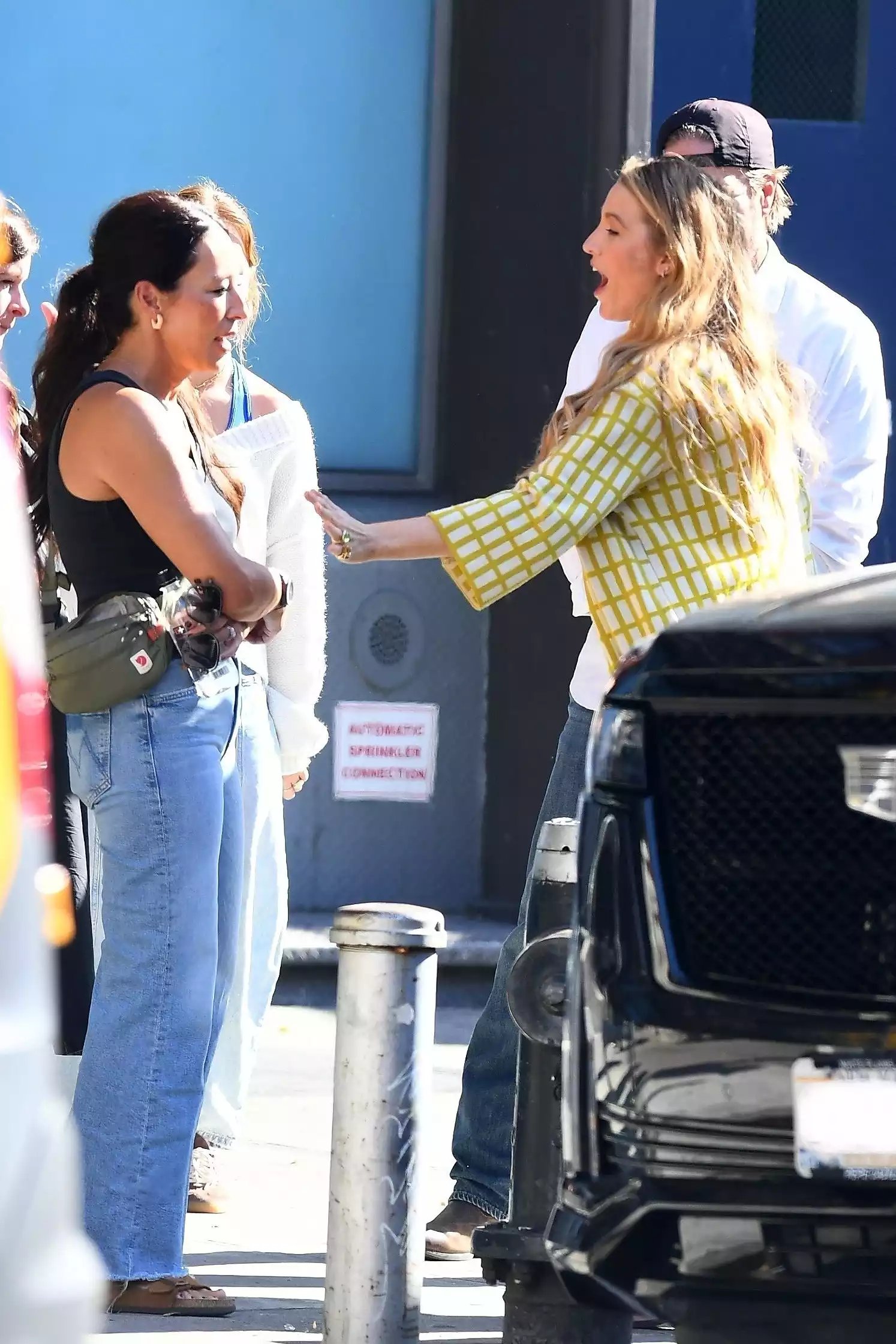 Blake Lively is seen leaving Gemma Restaurant, sharing a light moment as she steps out after a meal with Fixer Upper stars Chip and Joanna Gaines.