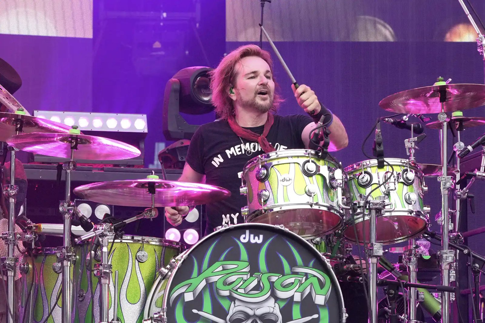 Rikki Rockett performing on stage playing drums