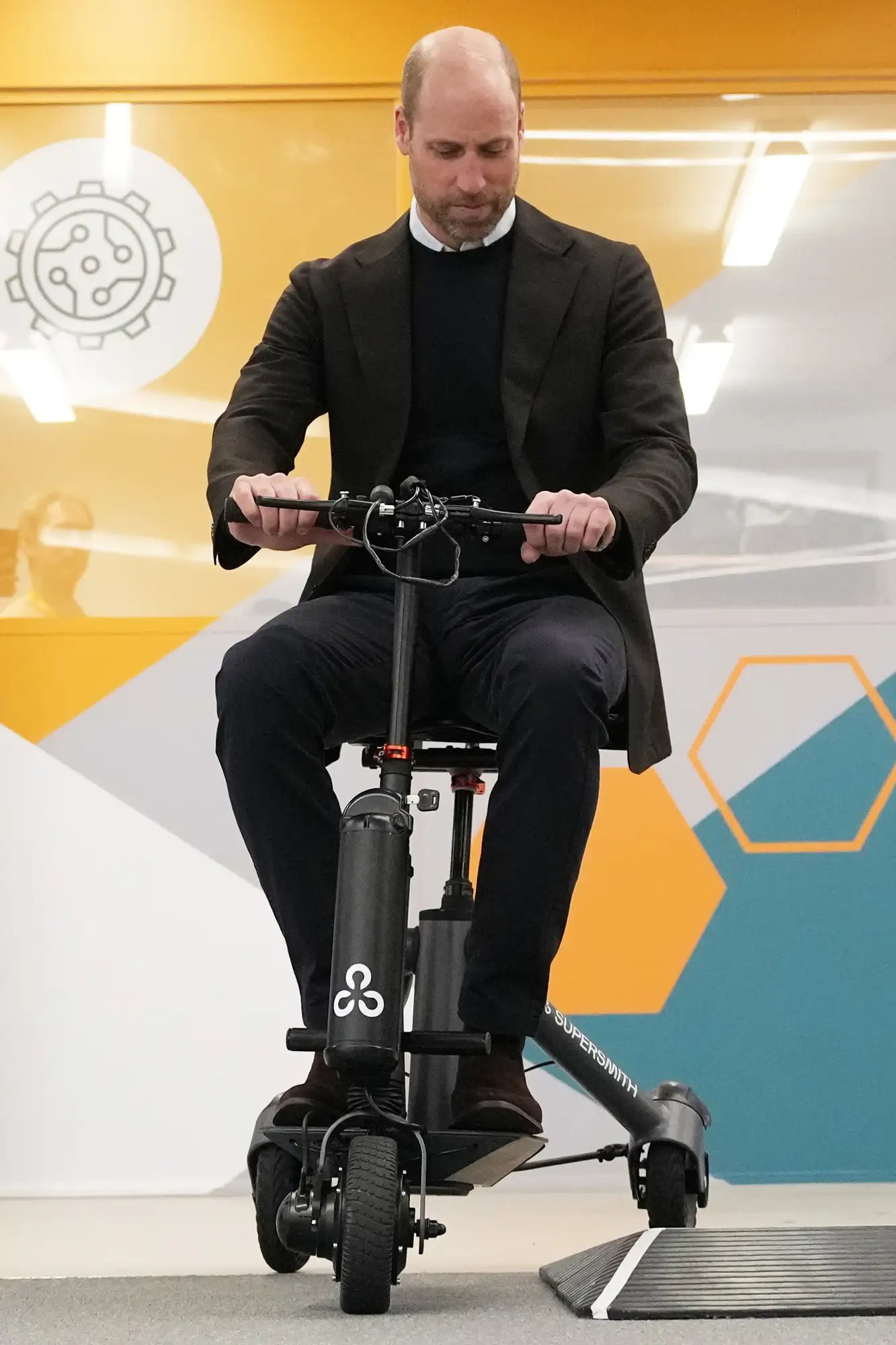 Prince William, Prince of Wales, rides on a lightweight mobility scooter at Bristol Robotics Laboratory 