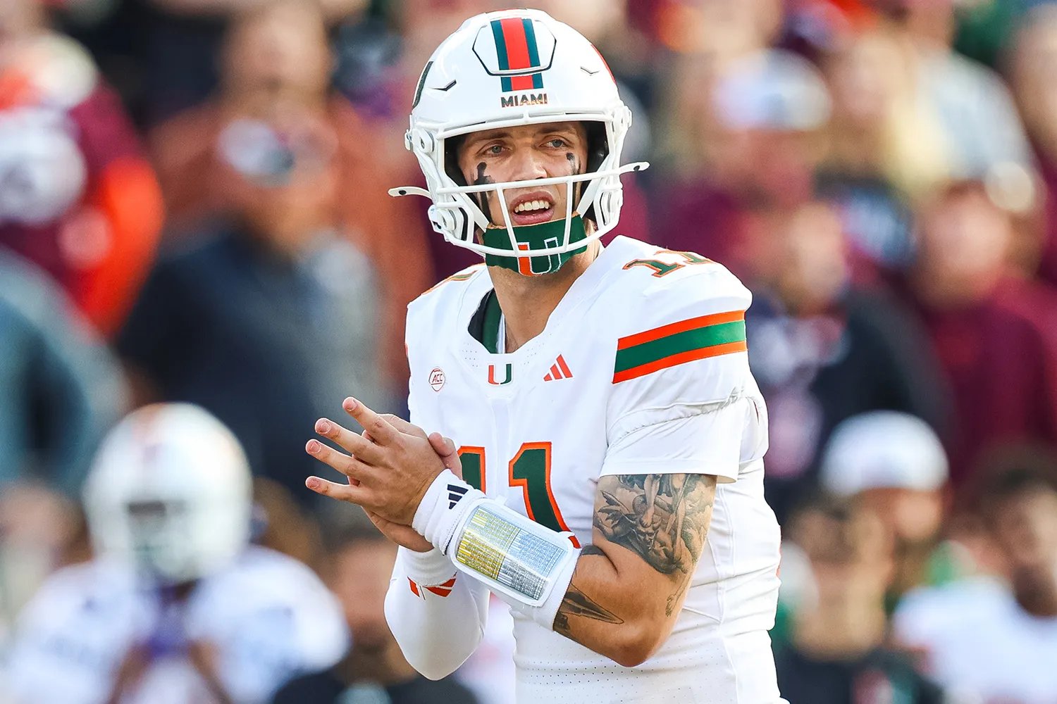 Carson Beck #11 of the Miami Hurricanes reacts in the first half during a game against the Virginia Tech Hokies at Lane Stadium