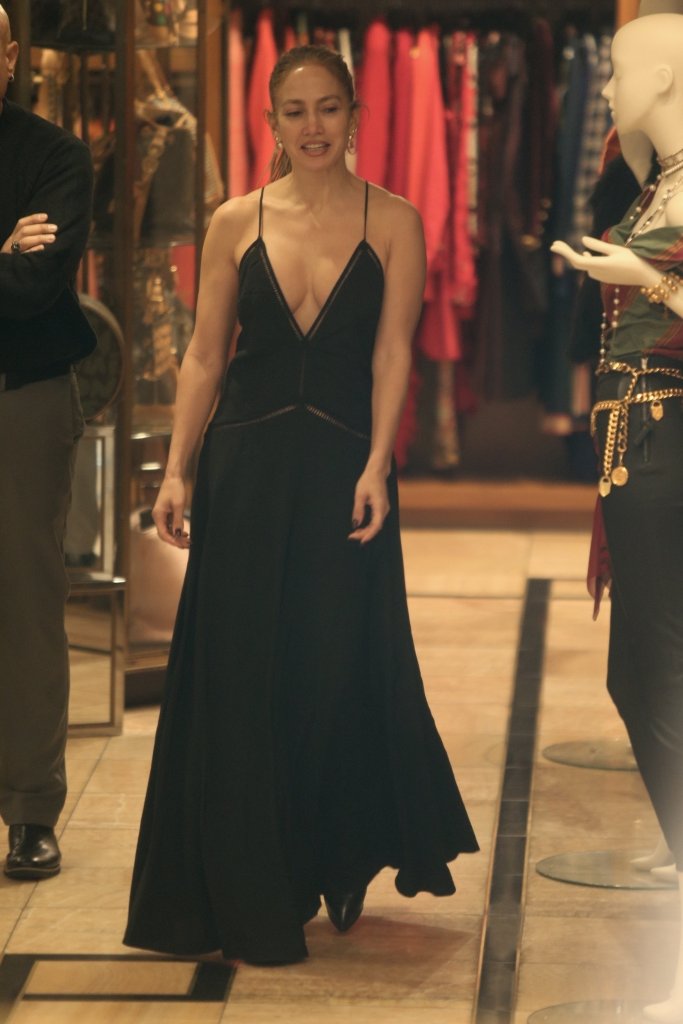 Jennifer Lopez in a black, V-neck, long dress at a vintage store.