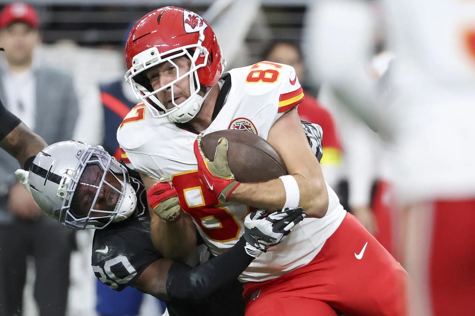 Isaiah Pola-Mao #20 of the Las Vegas Raiders tackles Travis Kelce #87 of the Kansas City Chiefs in the first quarter of a game at Allegiant Stadium on January 04, 2026