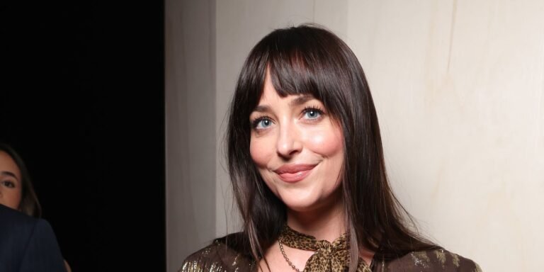 Dakota Johnson Stuns in a Bold Feathered Jacket and Sheer Tights During Paris Outing