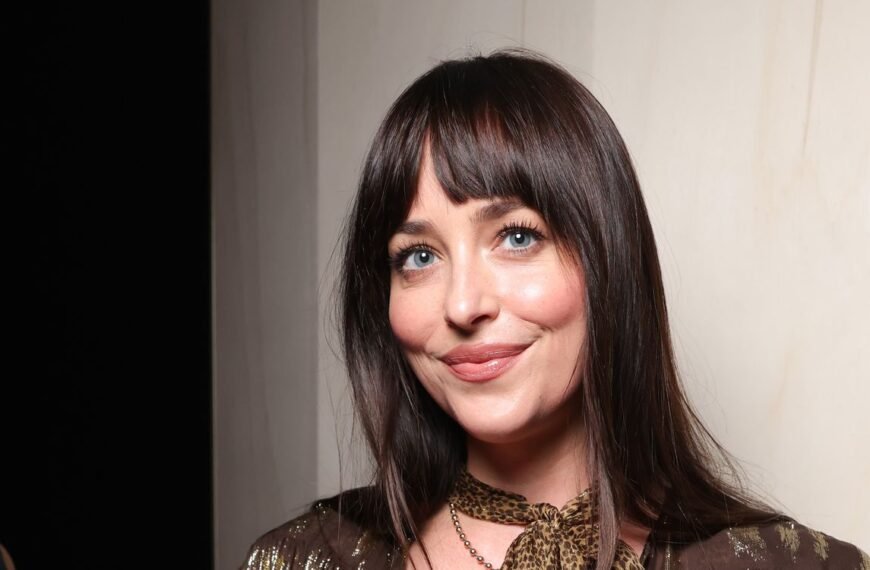 Dakota Johnson Stuns in a Bold Feathered Jacket and Sheer Tights During Paris Outing