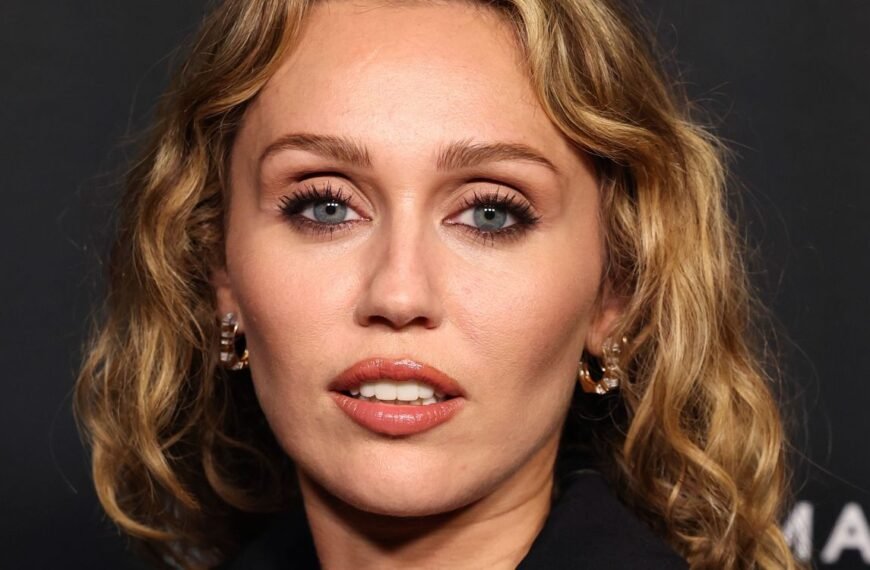 Miley Cyrus Wears a Bold Blouse with a Deep Cut and a Trendy Print
