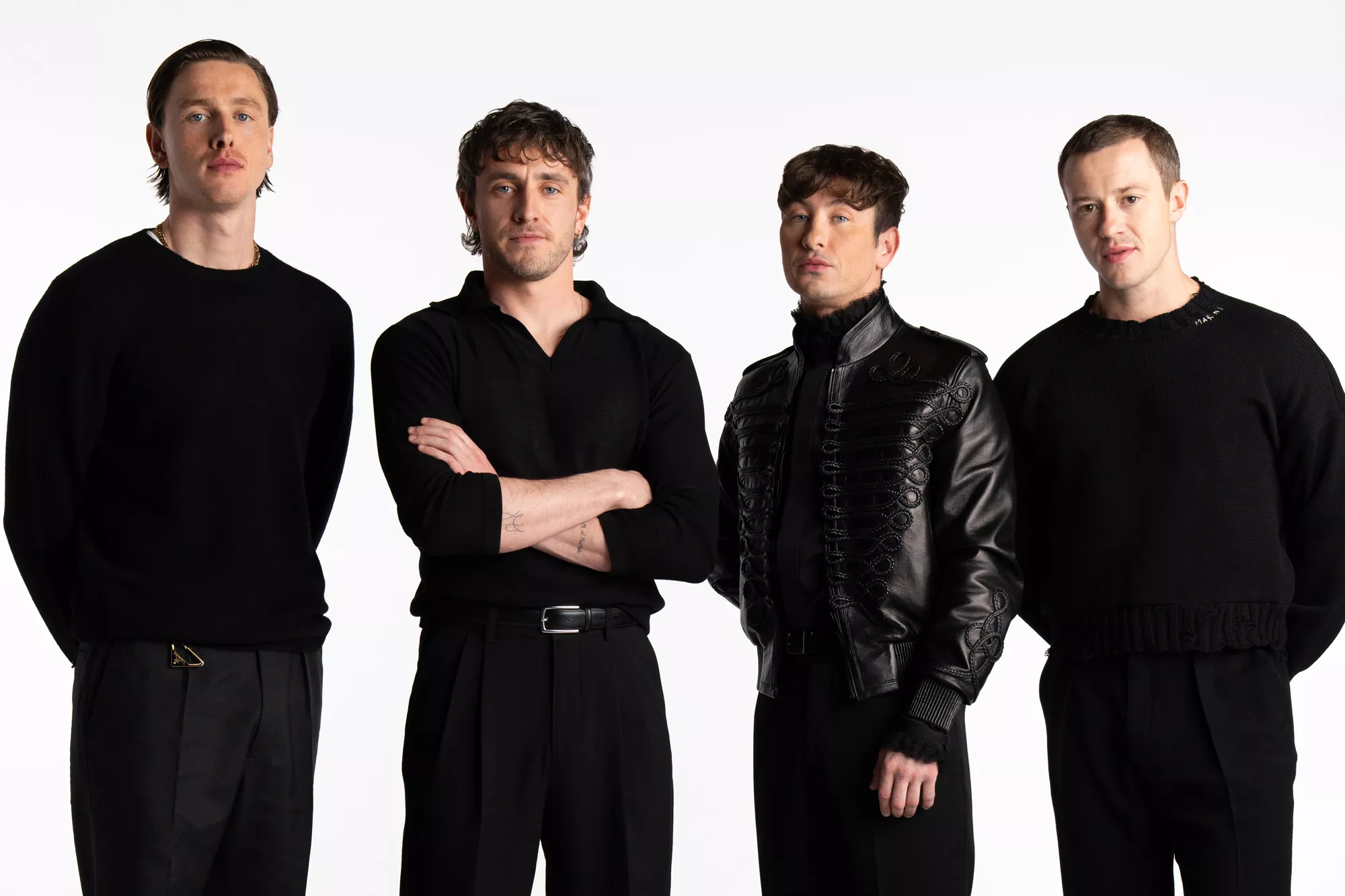 Harris Dickinson and three others posing for a photograph