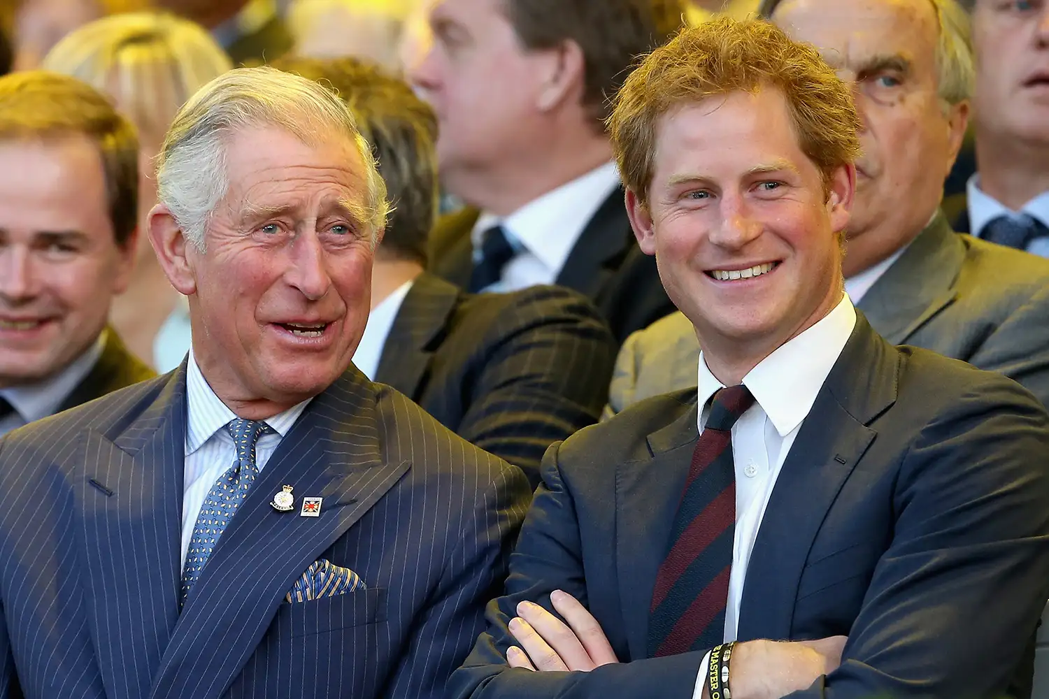 Prince Charles, Prince of Wales and Prince Harry laugh during the Invictus Games Opening Ceremony on September 10, 2014 in London, England