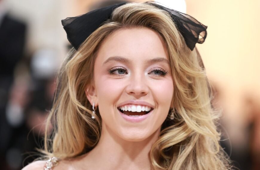 Sydney Sweeney Shines in a Chic Black Lace Bodysuit and Feather-Trimmed Boots