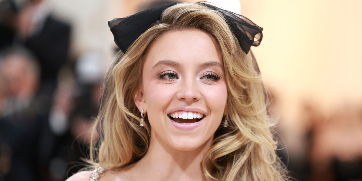 Sydney Sweeney Shines in a Chic Black Lace Bodysuit and Feather-Trimmed Boots