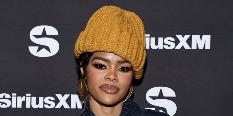 Teyana Taylor Styles a Sheer Lace Look with Chic Platform Heels and a Long Coat