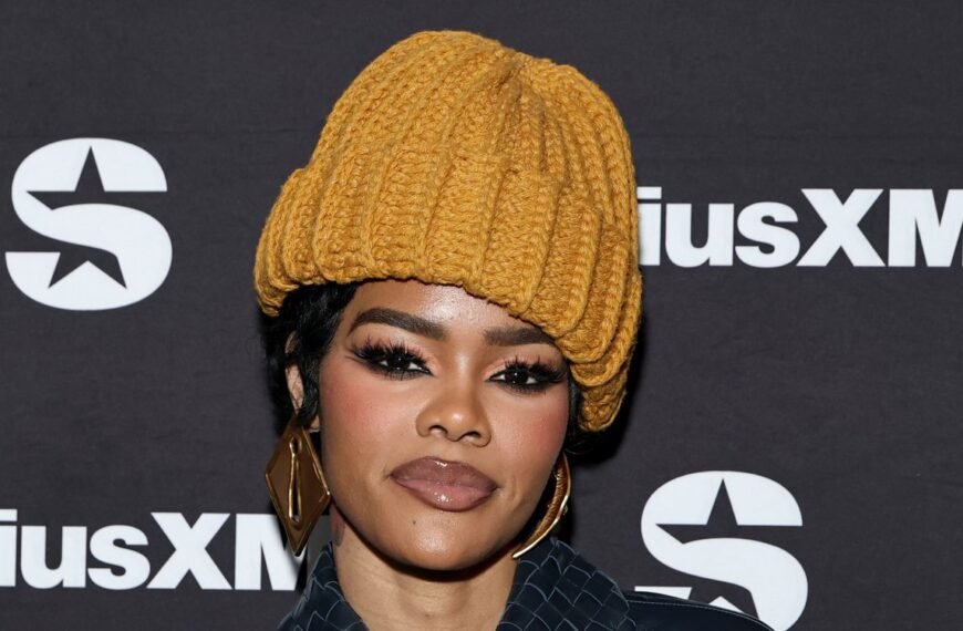Teyana Taylor Styles a Sheer Lace Look with Chic Platform Heels and a Long Coat