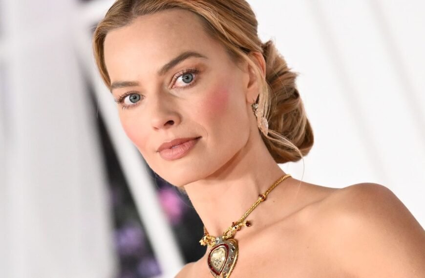 Margot Robbie Stuns in a Feathered Velvet Gown Paired with 100 Carats of Champagne Diamonds